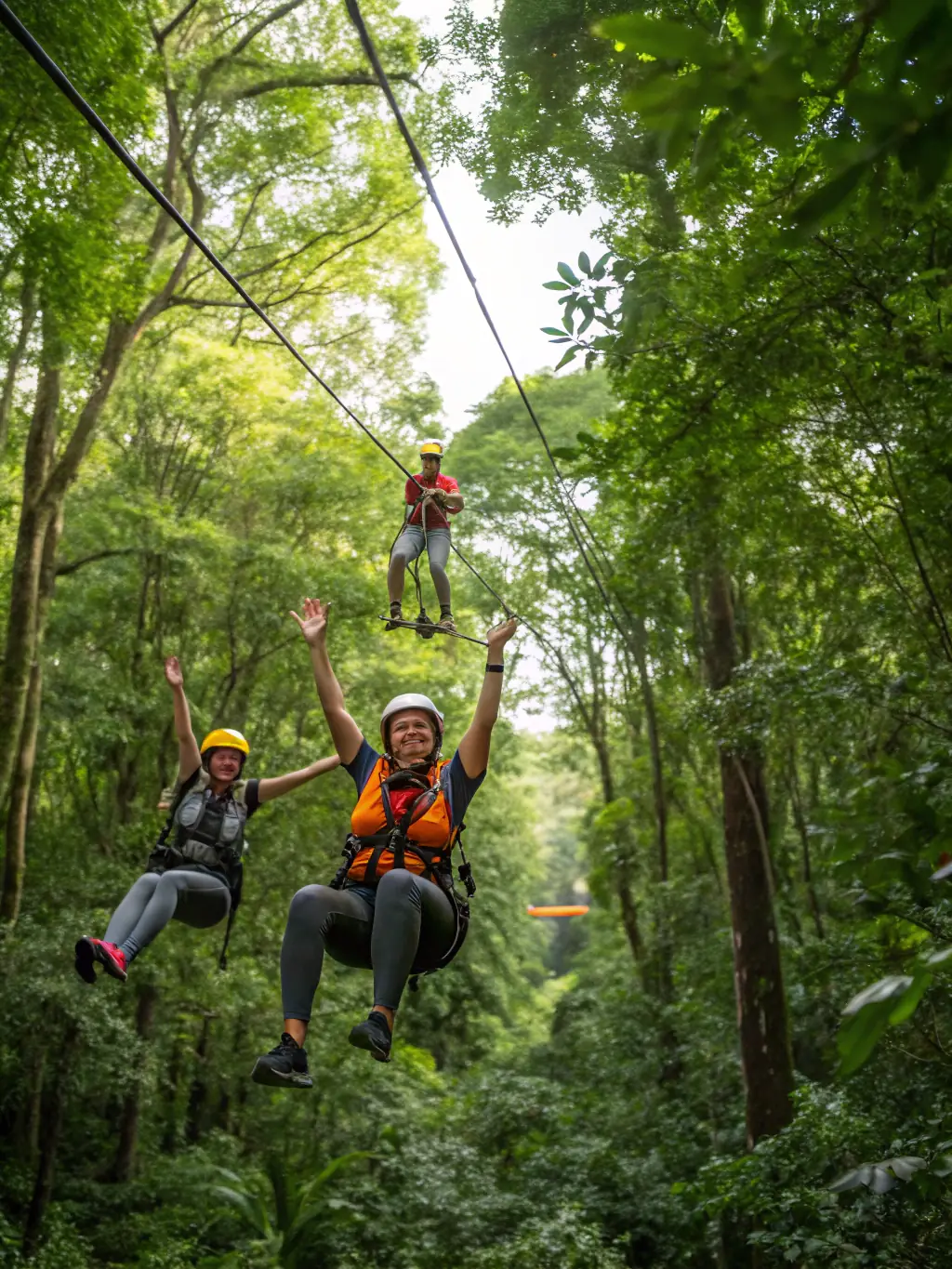 A close-up of a participant wearing a modern zipline helmet, harness, and gloves, with safety lines and carabiners clearly visible, set against a backdrop of green canopy.