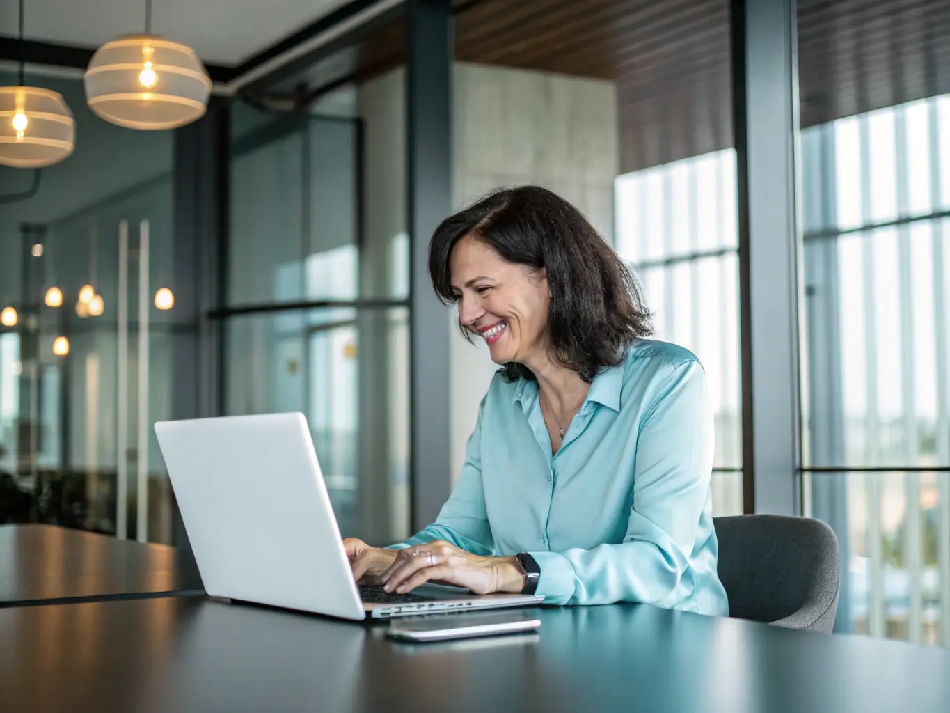 A cheerful business owner using a laptop in a bright, tropical coworking space, surrounded by plants and sunlight, representing the process of creating a business profile on a modern Costa Rican marketplace website.