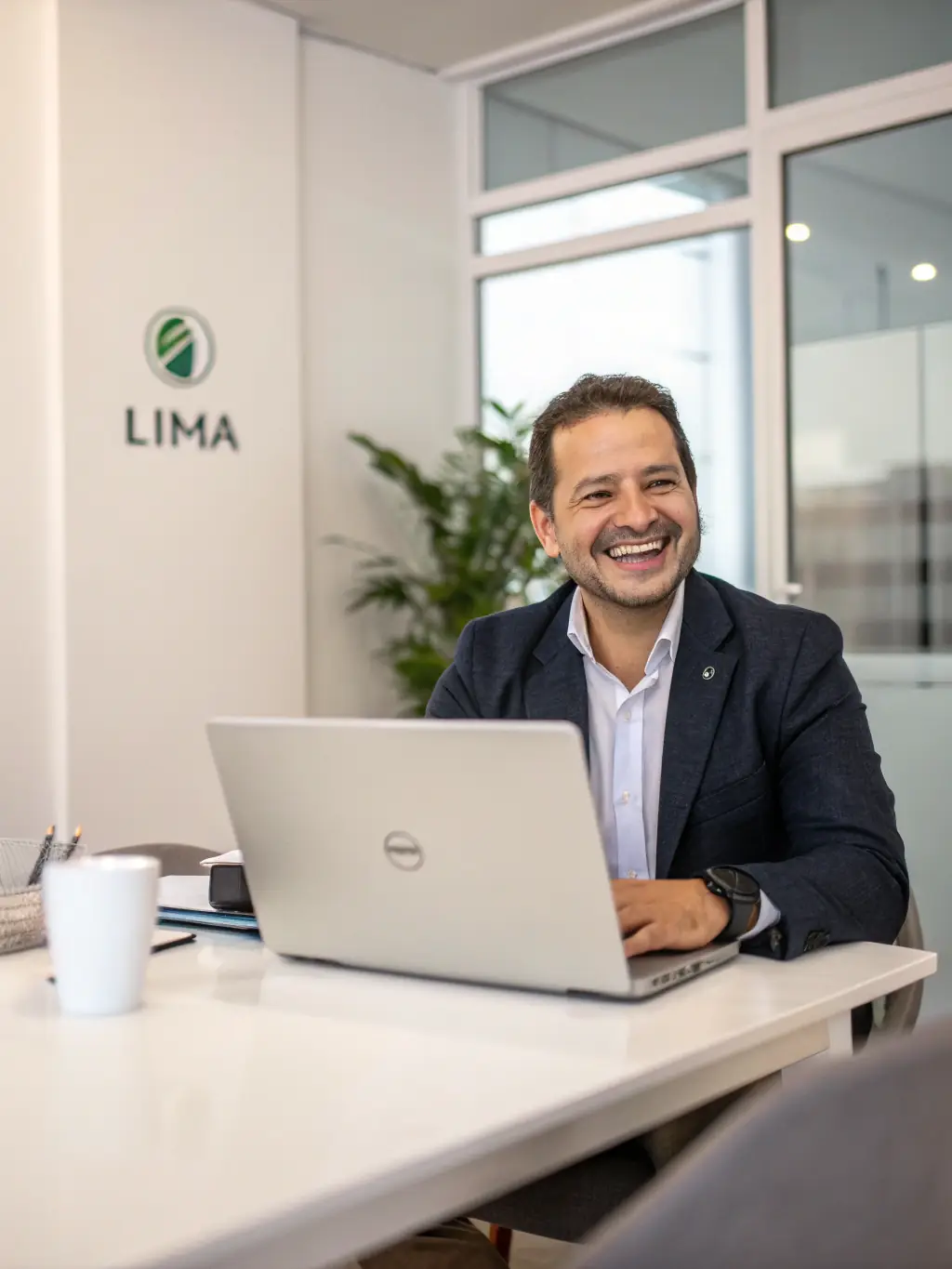 A vibrant image of a smiling Costa Rican professional using a laptop in a modern workspace, surrounded by tropical plants, conveying quick project posting in a premium marketplace.