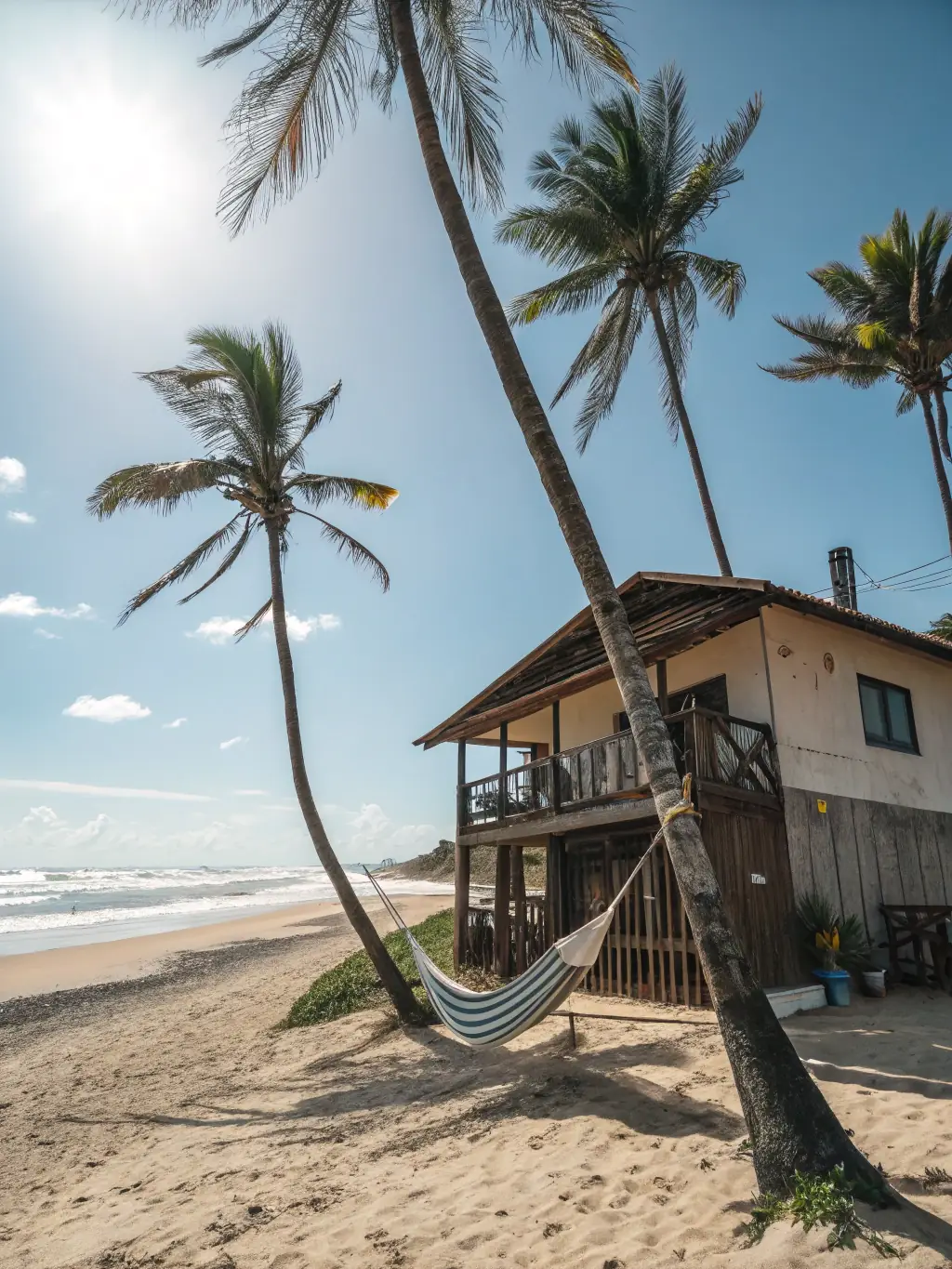 Colorful Caribbean houses, palm trees, and relaxed beachgoers in Puerto Viejo, with clear blue water and reggae vibes.